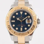 Rolex Yacht-Master two-tone watch with blue dial and gold bezel, luxury sports timepiece.